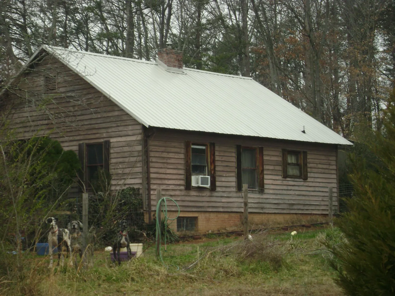 White metal roof on an old wood sided farmhouse, from a Metal Roof Installation job in Ceresco